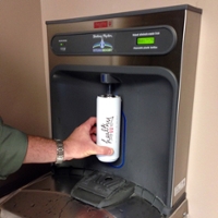 Healthy IU water-bottle being filled at a sustainable filling station at a water fountain