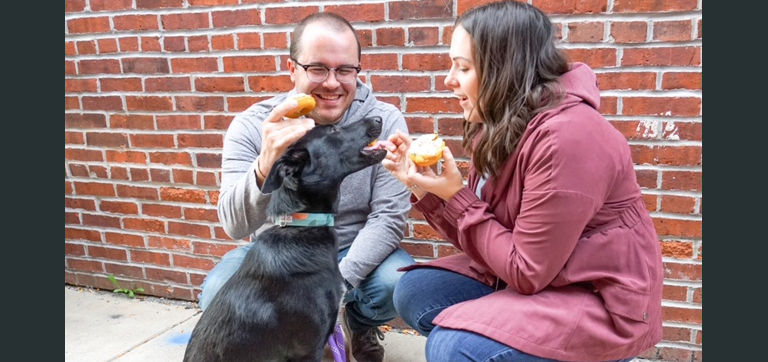 Lauren Daugherty and husband, Rob giving a dog a dog treat