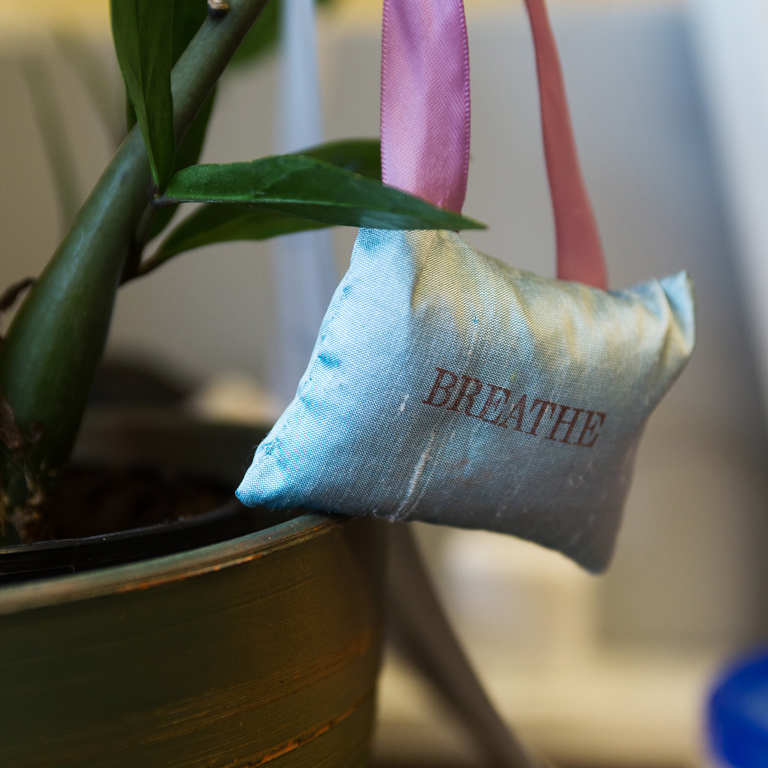 A pillow with the word "BREATHE" on it