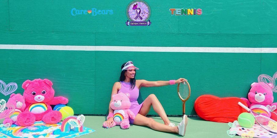 Rachel on a tennis court with Care-Bears